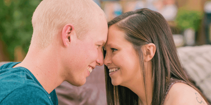 Happy couple smiling at each other.