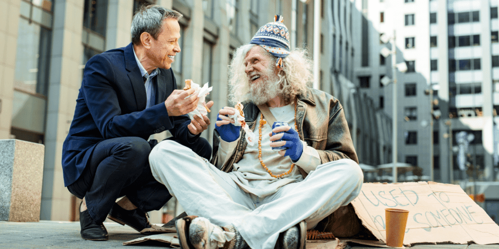 He should be kind. A man in a suit offers food to homeless man with a cardboard sign that says "used to be someone."
