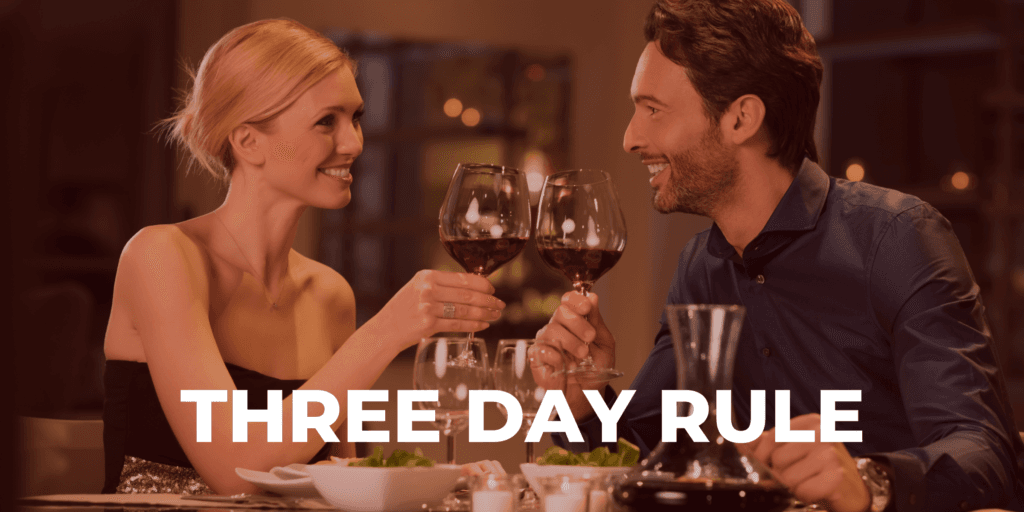 Image for matchmaking service Three Day Rule with a man and woman having an elegant dinner holding up glasses of red wine toasting each other.