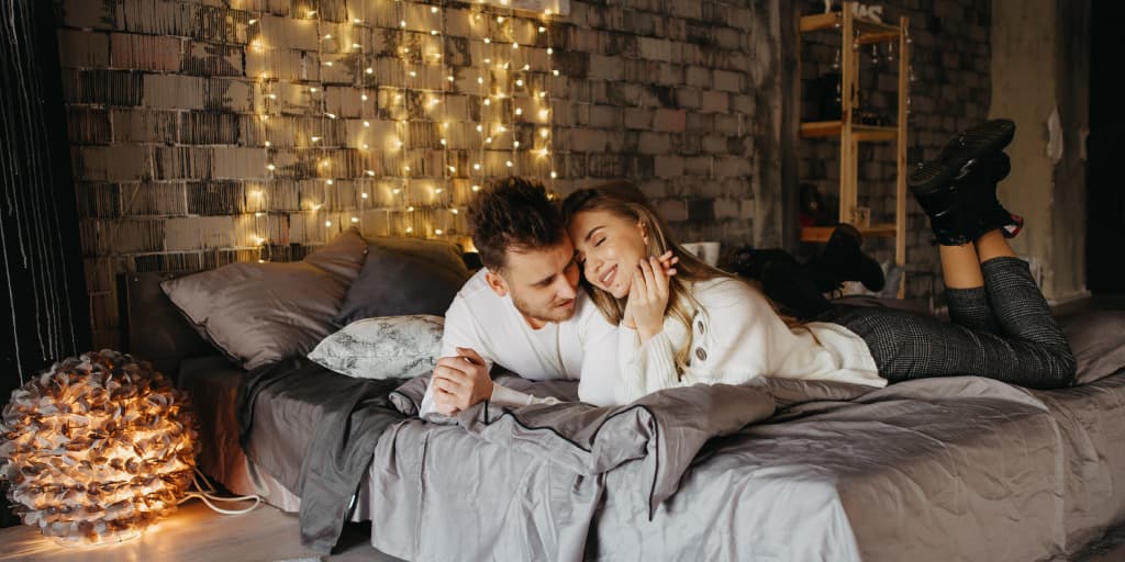 A busy American couple lay in bed together as part of their strategy to schedule intimacy into their relationship.